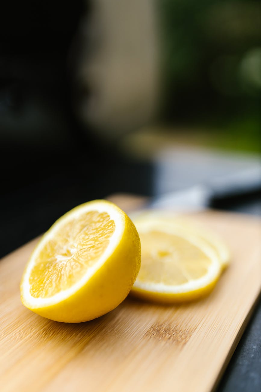 sliced lemon on brown wooden table